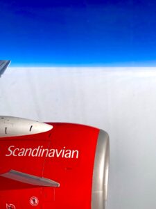 left airplane engine from window with Scandinavian Air branding