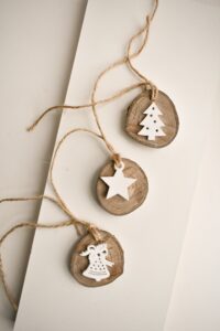 3 wooden handmade christmsa decorations tied by string